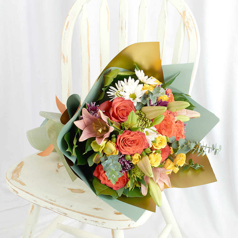 Mother's Day Love In Casablanca Deluxe Mixed Rose Bouquet, roses, lilies, daisies, spray roses, and spider mums along with eucalyptus and salal gathered in a floral wrap and tied with a designer ribbon, Mixed Floral Gifts from Blooms New Jersey - Same Day New Jersey Delivery.