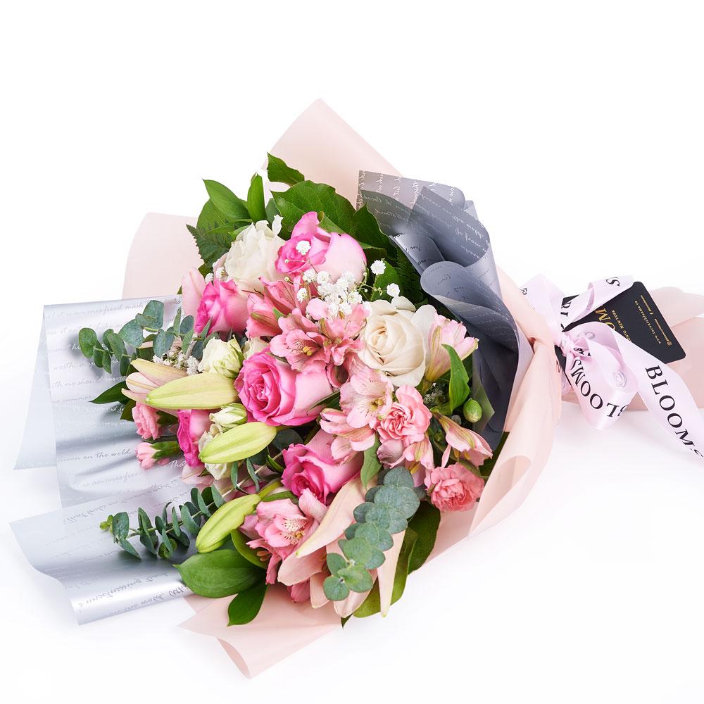 Pastel Dreams 12 Stem Mixed Rose Mother's Day Edition, roses, lilies, alstroemeria, and mini carnations in a floral wrap and tied with designer ribbon, Mixed Floral Gifts from Blooms New Jersey - Same Day New Jersey Delivery.