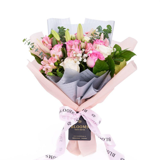 Pastel Dreams 12 Stem Mixed Rose Mother's Day Edition, roses, lilies, alstroemeria, and mini carnations in a floral wrap and tied with designer ribbon, Mixed Floral Gifts from Blooms New Jersey - Same Day New Jersey Delivery.