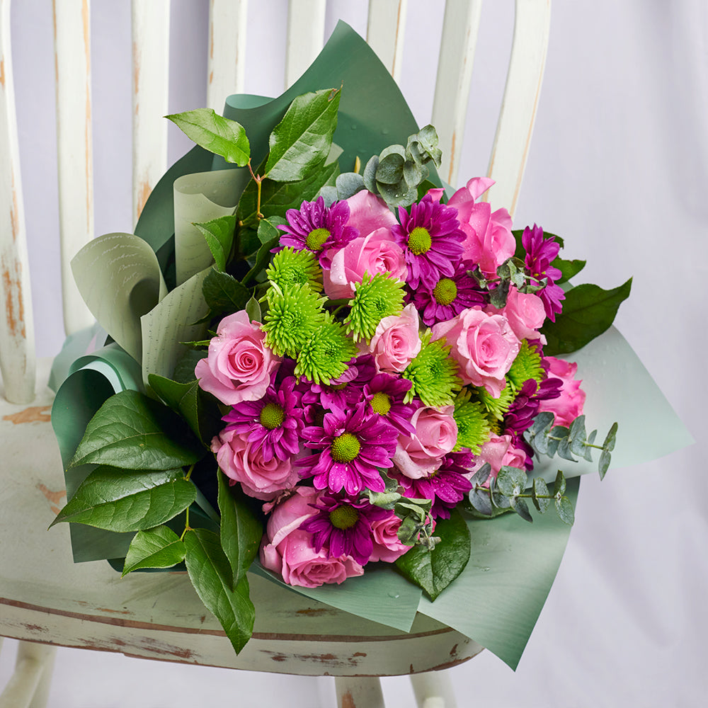 Mother's Day Secret Garden Mixed Floral Bouquet, roses, daisies, eucalyptus, and salal gathered in a floral wrap and tied with designer ribbon, Mixed Floral Gifts from Blooms New Jersey - Same Day New Jersey Delivery.
