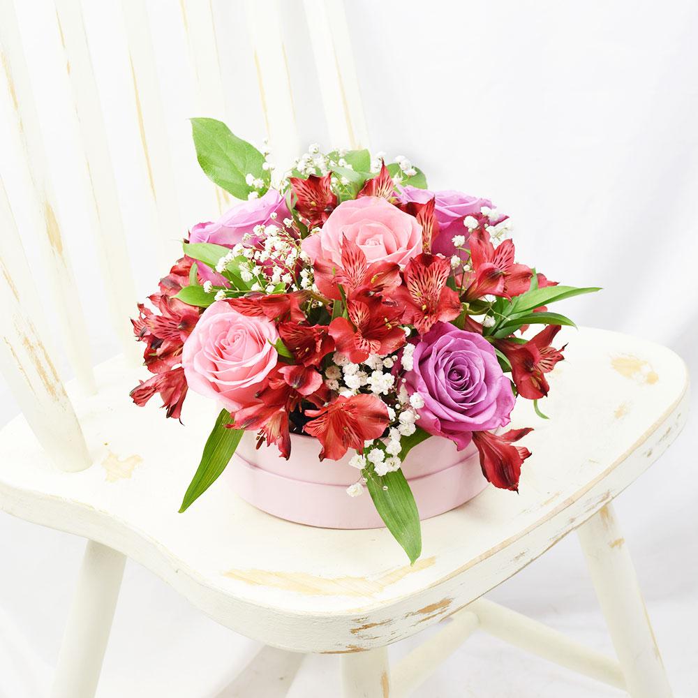Soft Radiance Mixed Arrangement, red alstroemeria and a selection of pink and purple roses with ruscus and baby’s breath in a short pink designer hat box, Mixed Floral Gifts from Blooms New Jersey - Same Day New Jersey Delivery.