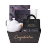Graduation Tea Time Gift, dark chocolate high heels, vanilla chai, champagne-inspired chocolate truffles, a champagne-inspired chocolate bar, chocolate chip mocha cookies, a beautiful tea pot, and a Congratulations market tray, Graduation Gifts from Blooms New Jersey - Same Day New Jersey Delivery.