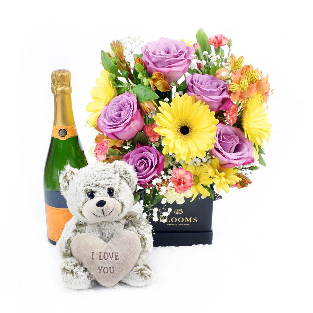 The Extravagant Floral Sunrise Mixed Arrangement &amp; Gift Set, roses, alstroemeria, gerbera, mini carnations, spider chrysanthemum, daisies, and baby’s breath arranged carefully in a square black designer hat box, soft teddy bear, bottle of Sparkling Wine, Floral Gifts from Blooms New Jersey - Same Day New Jersey Delivery.