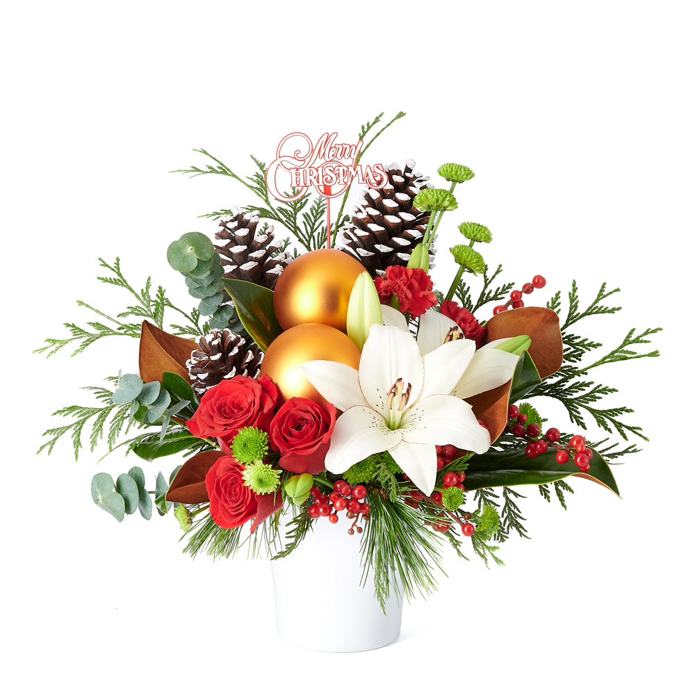 Joyous Christmas Floral Arrangement, roses, lilies, chrysanthemums, berries, greenery, pine cones, ornaments, and a Christmas decoration all arranged artfully into a ceramic pot, mixed flower gifts from Blooms New Jersey - Same Day New Jersey Delivery.